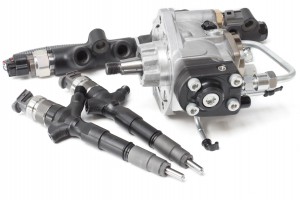 Two new solenoid injectors for diesel fuel lying on a white background with a rod and a fuel injection pump